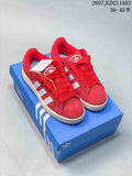 Red Adidas Campus sneakers with white side stripes shown on a blue shoe box