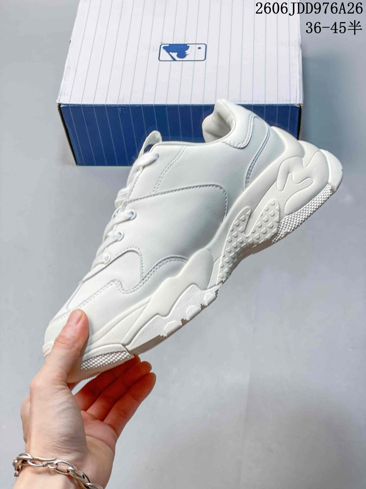 Side profile showing the white layered upper, padded collar and sculpted chunky sole.