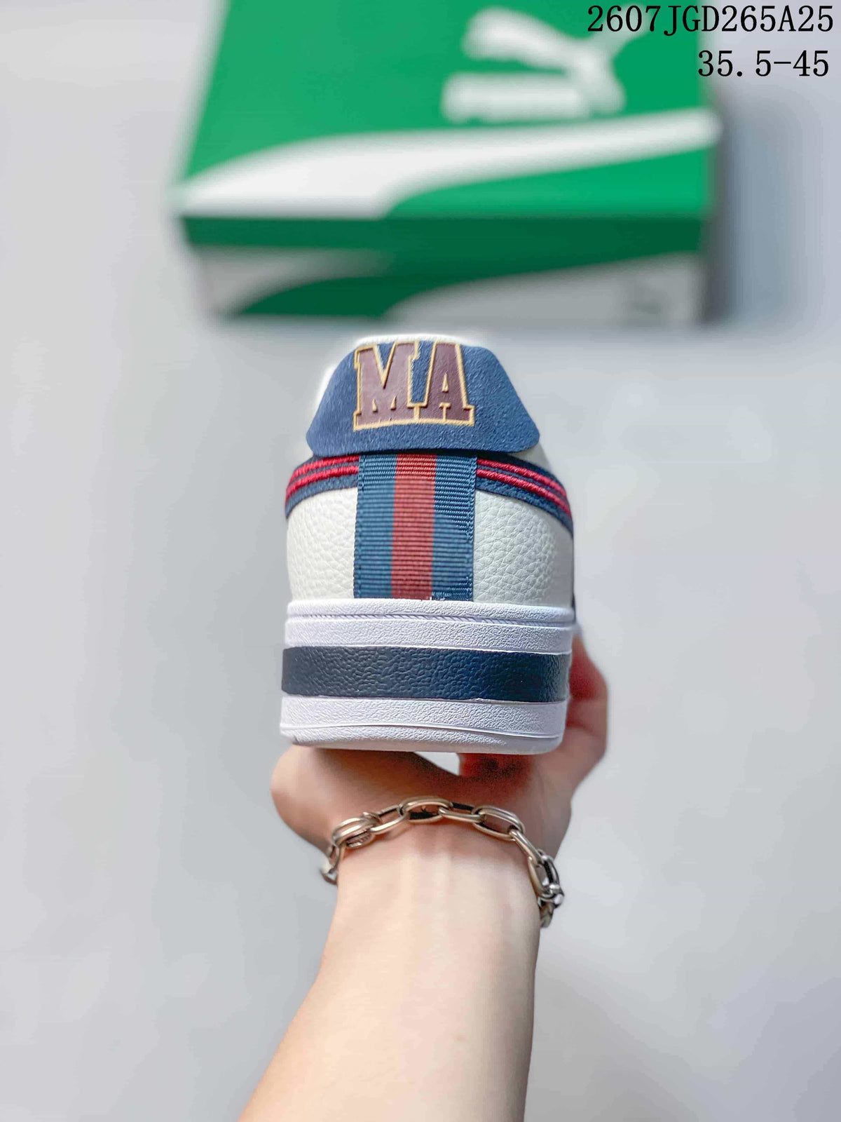 Rear view of the sneaker showing the navy-and-red heel stripe and PUMA-branded heel tab.