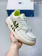 Close view of a white MLB Chunky Liner sneaker with bright yellow-green accents