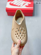 Top view of the tan clog showing the perforated forefoot and open slip-on entry.