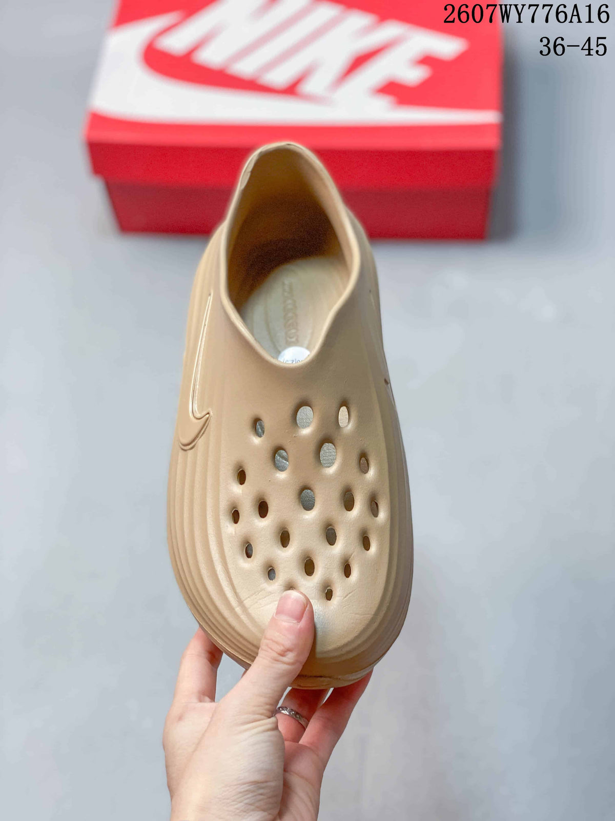 Top view of the tan clog showing the perforated forefoot and open slip-on entry.