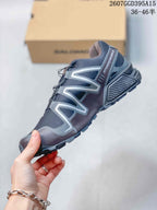 Side view of a Salomon Speedcross 3 shoe showing gray structural overlays, mesh panels, heel cushioning, and trail outsole.