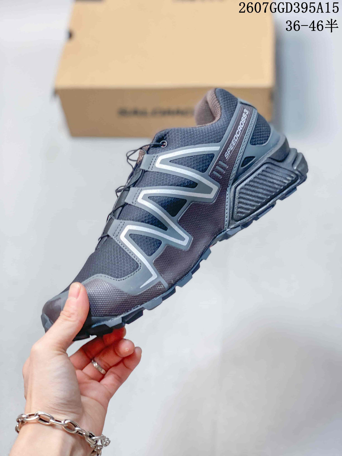 Side view of a Salomon Speedcross 3 shoe showing gray structural overlays, mesh panels, heel cushioning, and trail outsole.