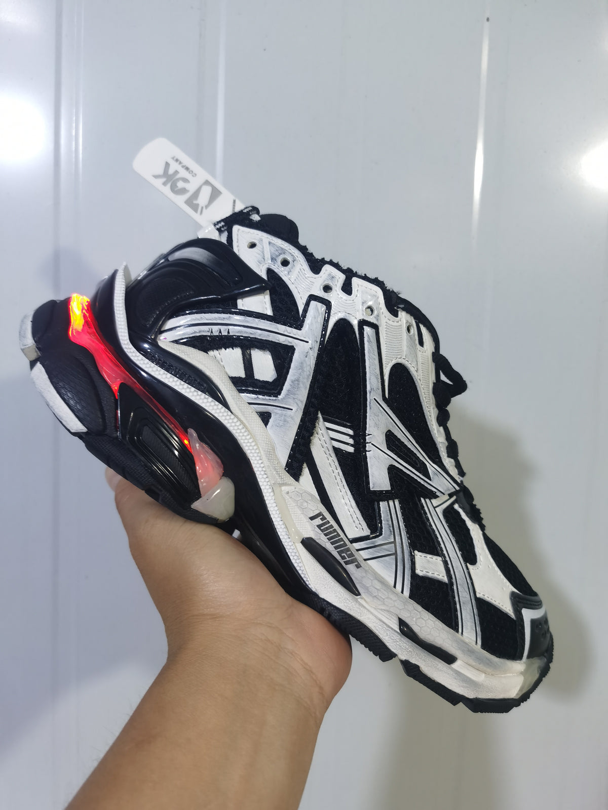 Rear three-quarter view of the Puma 9010 runner sneaker showing the layered heel and colored heel detail.