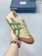 Beige Onitsuka Tiger Mexico 66 slip-on sneaker with green side stripes, a brown toe overlay, and a gum-colored outsole.