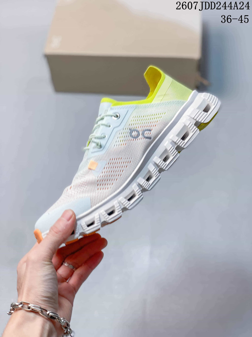 Side view of the sneaker showing the pale blue and white upper, lace fastening, perforated panels, and segmented outsole.