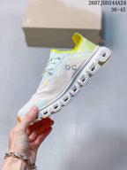 Side view of the sneaker showing the pale blue and white upper, lace fastening, perforated panels, and segmented outsole.