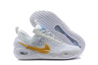 White Nike Anthony basketball shoes with gold-colored side accents.