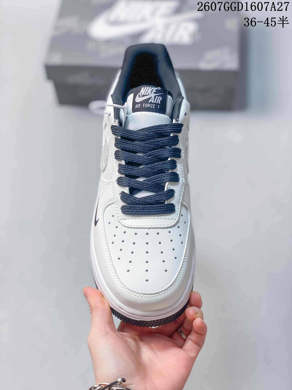 Top view showing the perforated white toe box, dark laces, padded collar, and Nike Air Force 1 tongue label.