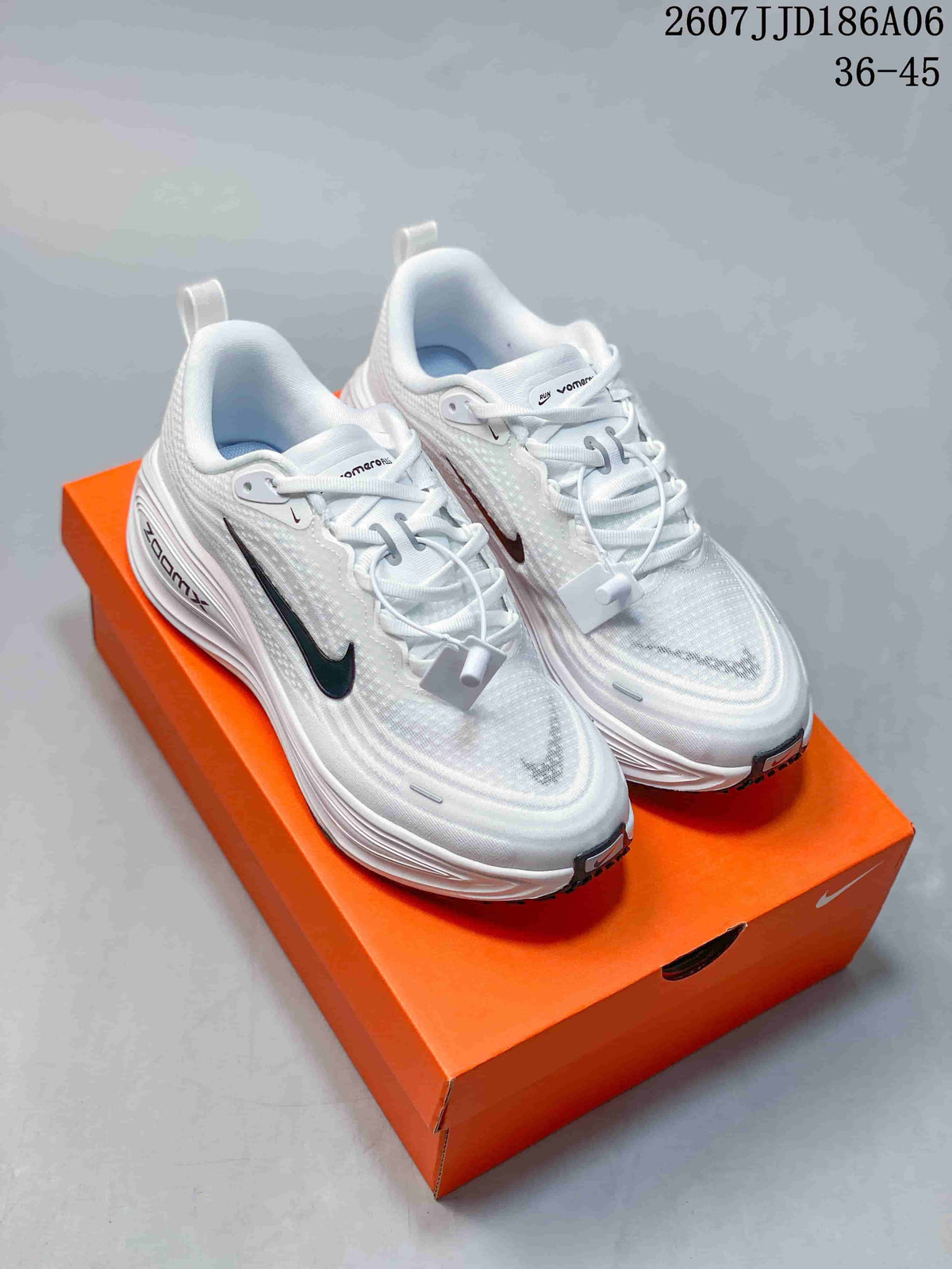 Pair of white Nike Vomero 18 GTX running shoes with black Swoosh accents displayed on an orange shoebox.