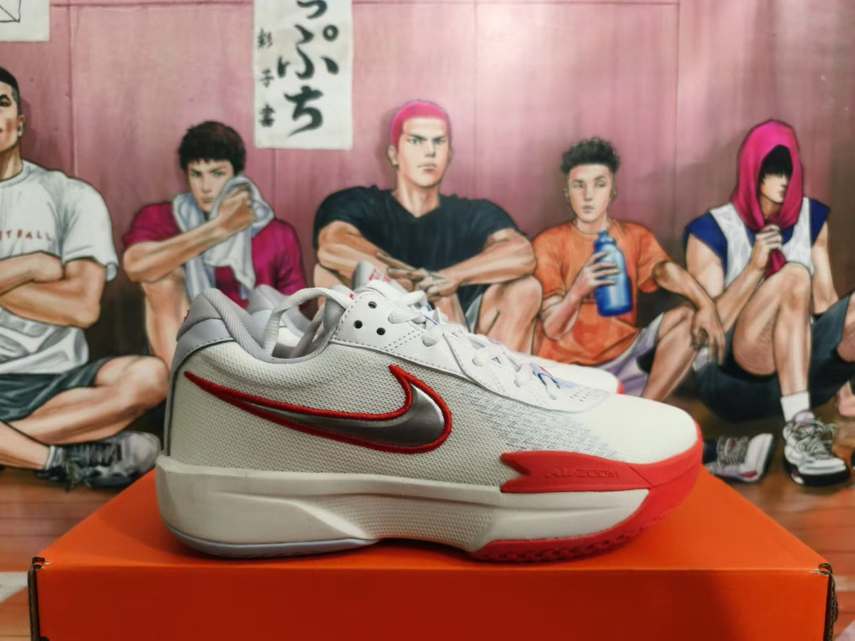 Side view showing the Swoosh logo and red accents on a white Nike basketball shoe