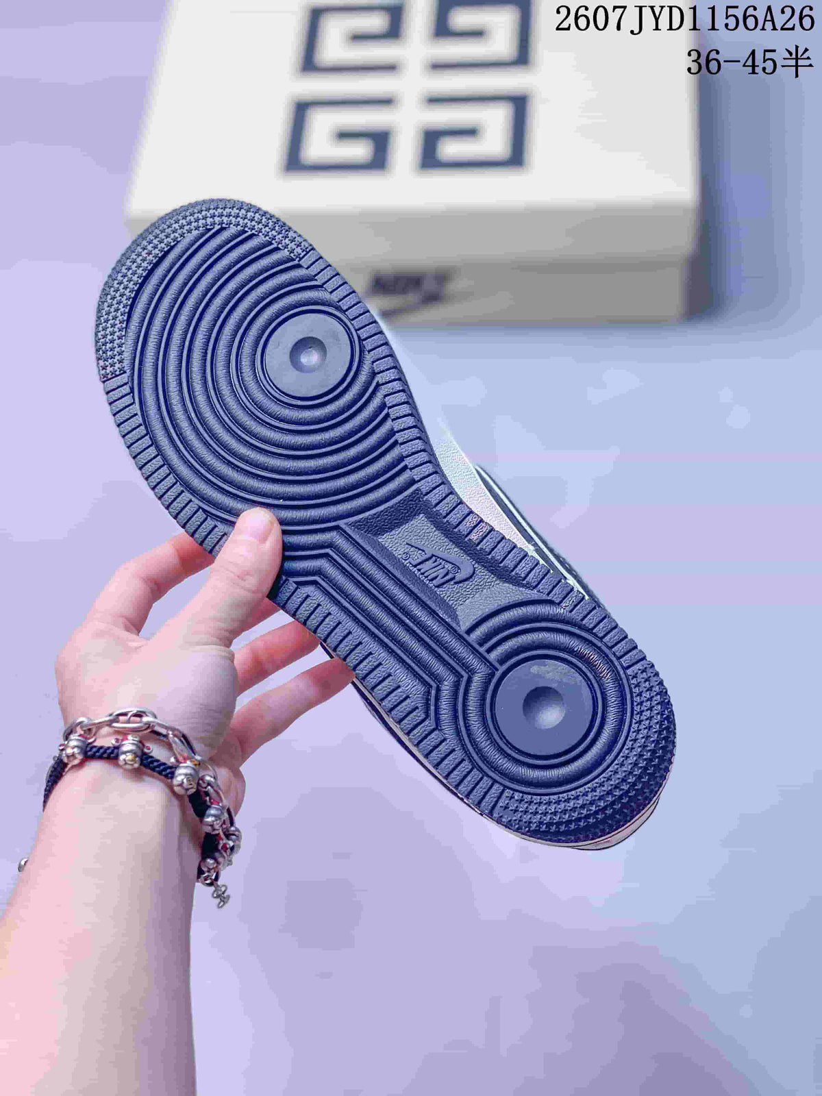 Underside view of the sneaker showing the navy rubber outsole with concentric circular traction grooves.