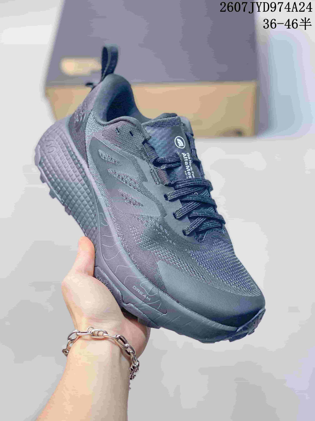 Angled side view of the dark gray The North Face Altamesa 500 sneaker showing the lace-up upper, side branding, and trail-style outsole.
