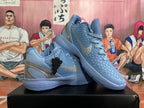 Pair of blue-gray Nike Kobe basketball shoes arranged at an angle