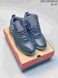 Pair of dark Jordan Air Jordan 12 Retro sneakers displayed on a branded shoebox, with red accents and the size range 36–47 shown at the top.