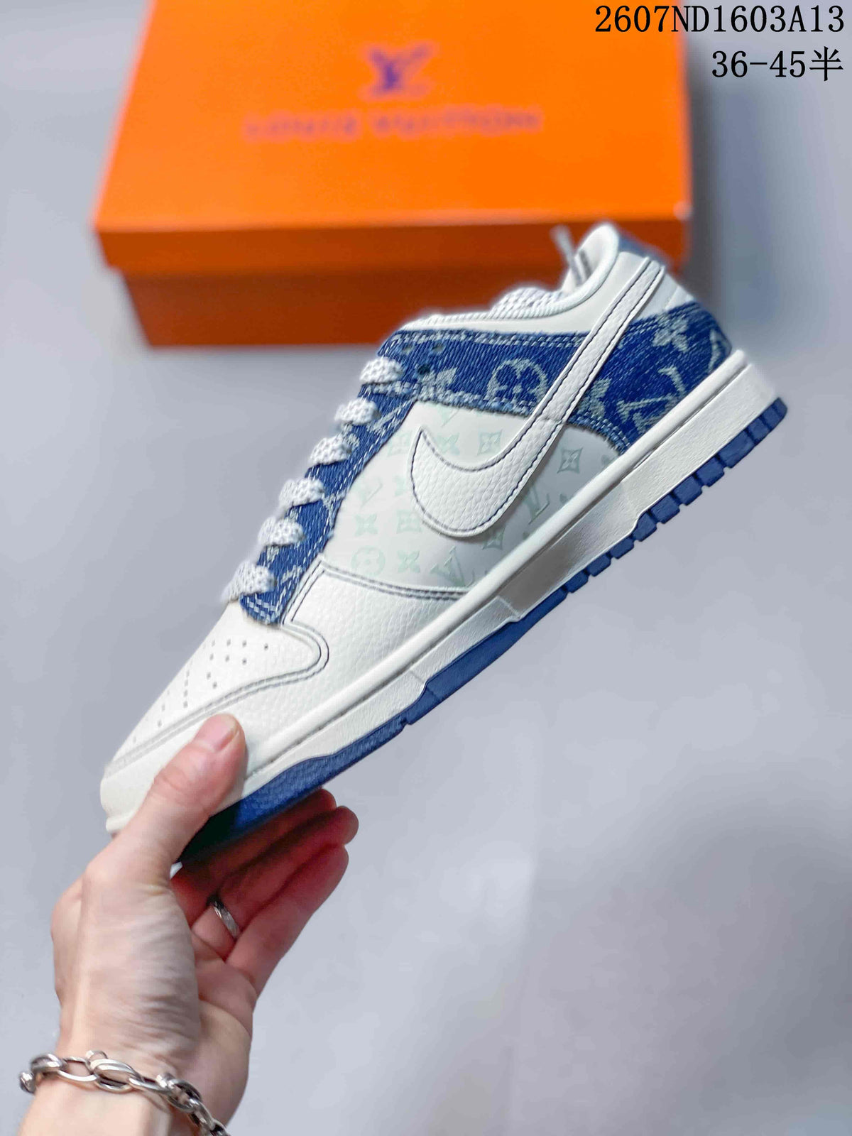 Side profile showing the white midsole, blue patterned overlays, white side swoosh, and printed side panel.