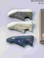 Pair of light sage The North Face Dune sneakers with knit-look uppers displayed on a shoe box.