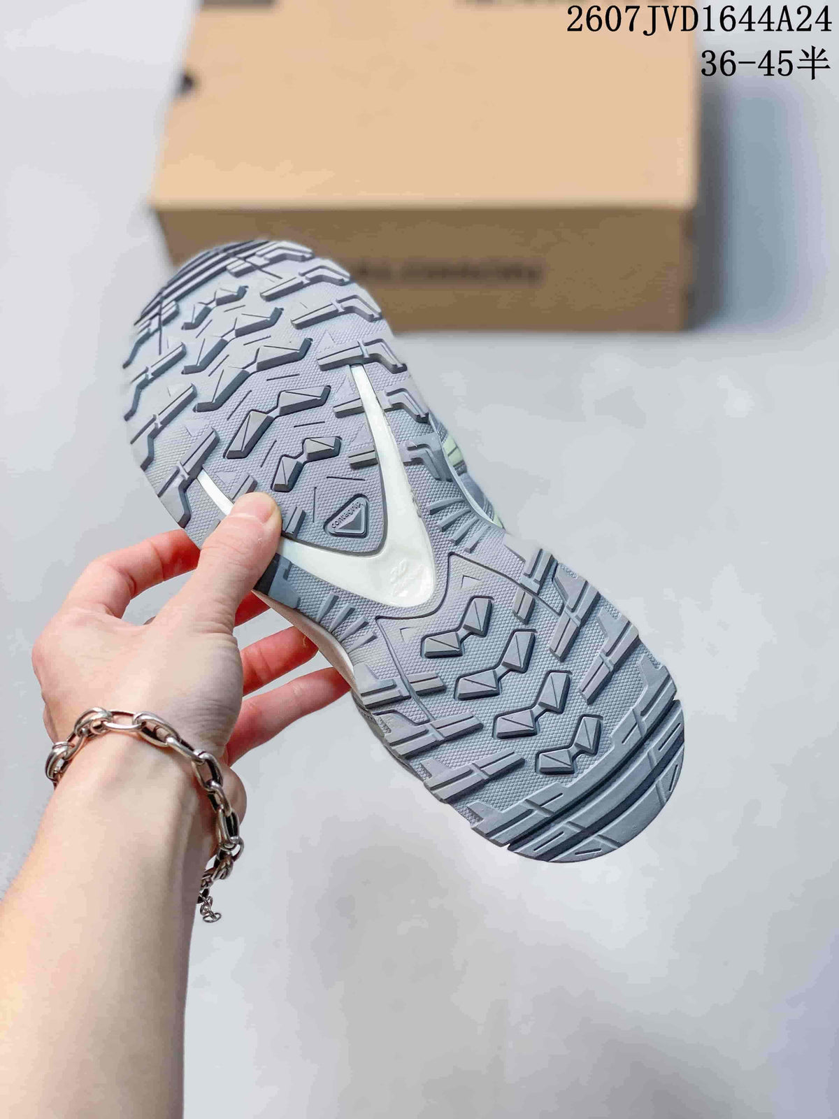 Close view of the sneaker outsole showing a light gray lugged tread pattern and segmented traction design.