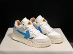 Front three-quarter view of the pair highlighting the white upper, blue side arrows, and cream-colored soles.