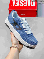 Angled view of a blue denim-look low-top sneaker with white laces and a black side accent.