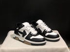 Three-quarter front view of the black and white low-top sneaker pair.