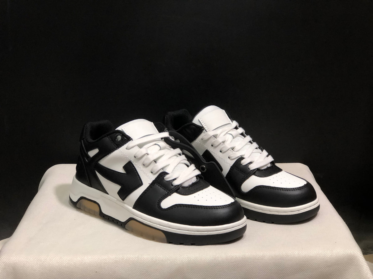 Three-quarter front view of the black and white low-top sneaker pair.