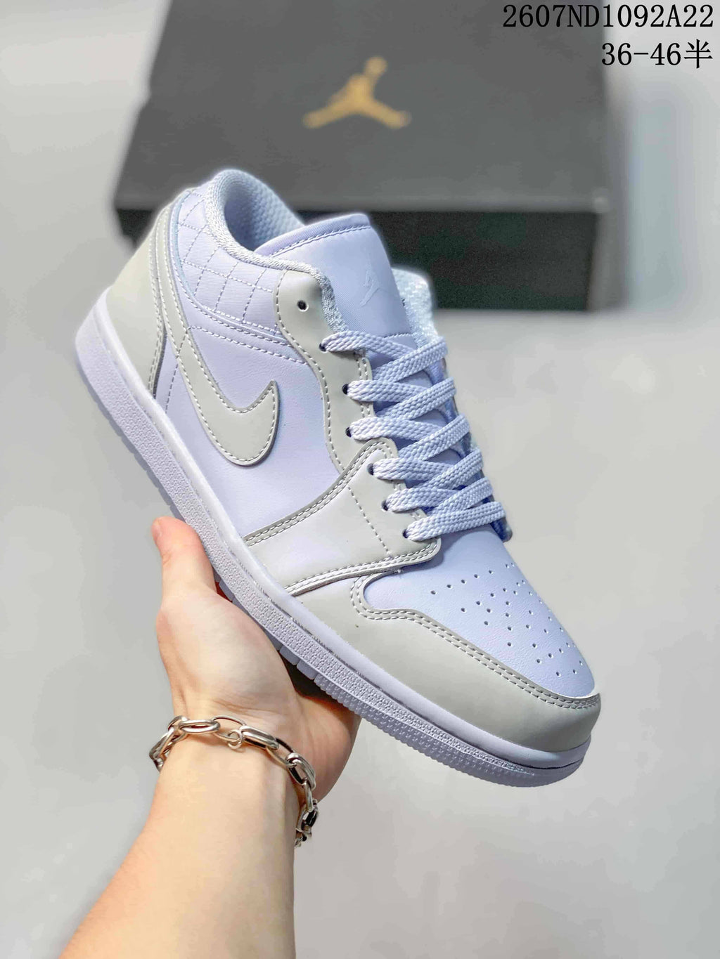 Close side view showing the low-top silhouette, layered panels, white overlays, and light lavender upper.