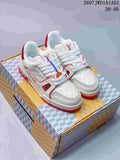 Pair of white and red Louis Vuitton Trainer low-top sneakers on a patterned box