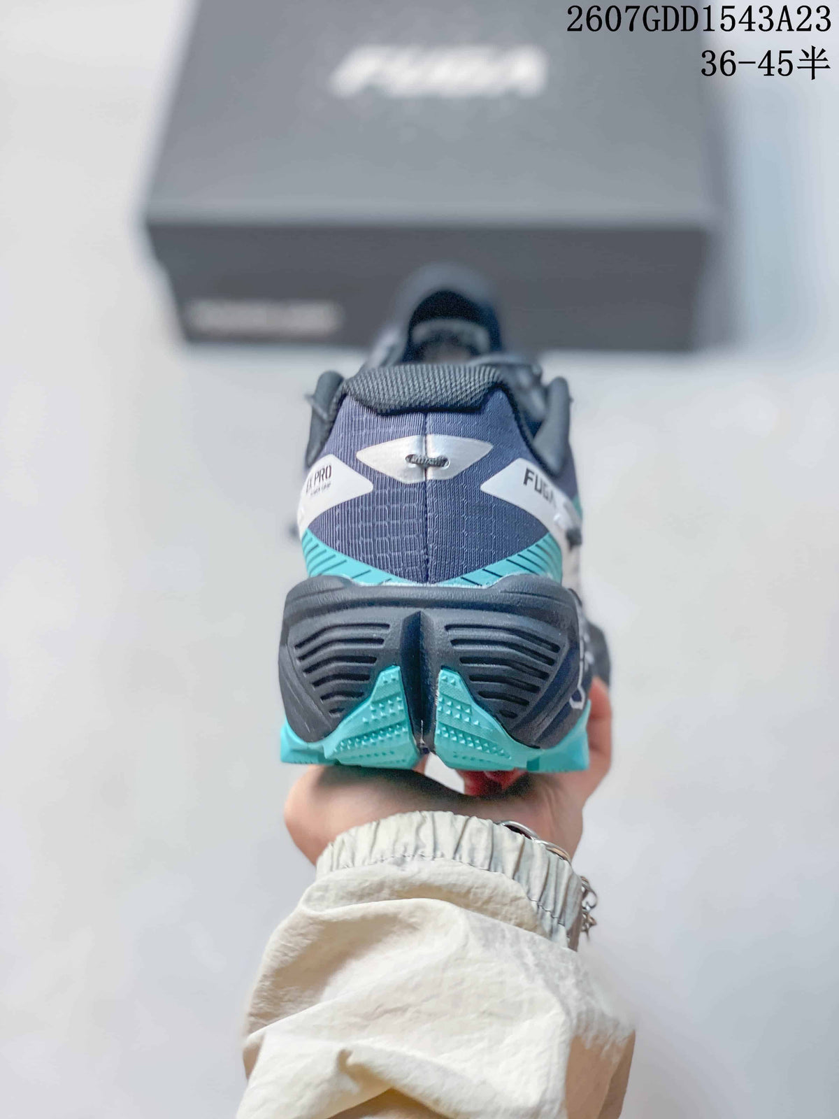 Rear view of the Kailas trail running shoe showing the padded heel, black midsole structure and teal outsole sections.