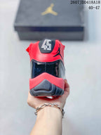 Rear view showing the red collar, black glossy heel panel, Jordan branding, and layered outsole.