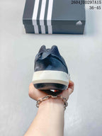 Rear view of the navy shoe showing the padded heel, white midsole, and dark outsole.