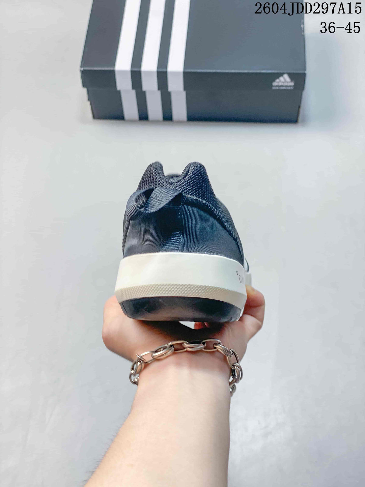 Rear view of the navy shoe showing the padded heel, white midsole, and dark outsole.
