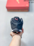 Rear view of the black sneaker showing the padded heel and red Puma logo.
