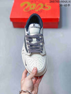 Top view showing the perforated white toe box, patterned laces, navy collar, and branded tongue.