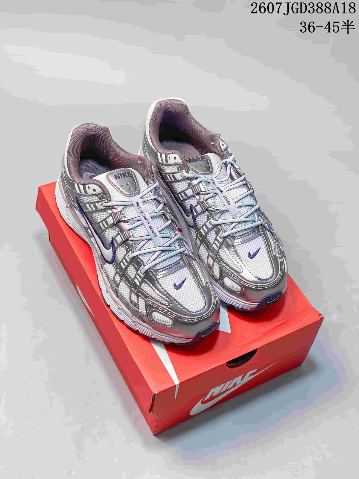 Pair of Nike P-6000 sneakers in white, purple and pink displayed on a red shoebox; overlay text shows style code 2607JGD388A18 and sizes 36–45.