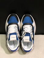 Top view showing blue textured panels, black overlays, white laces, and branded tongue labels.