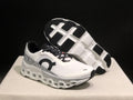 White and black On Cloudmonster 2 shoes showing the outsole and side profile