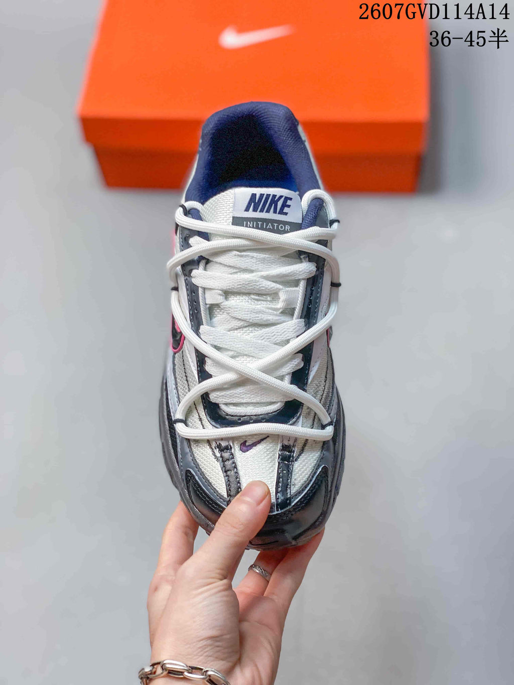 Top view showing the white laces, tongue branding, gray panels, and black overlays.
