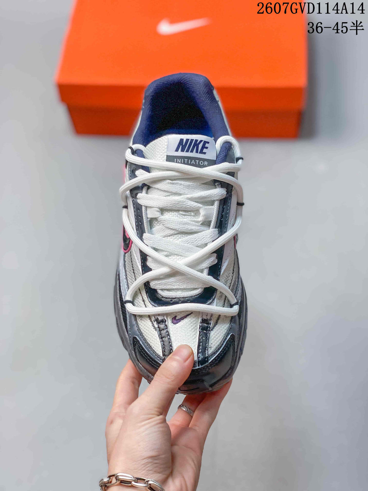 Top view showing the white laces, tongue branding, gray panels, and black overlays.