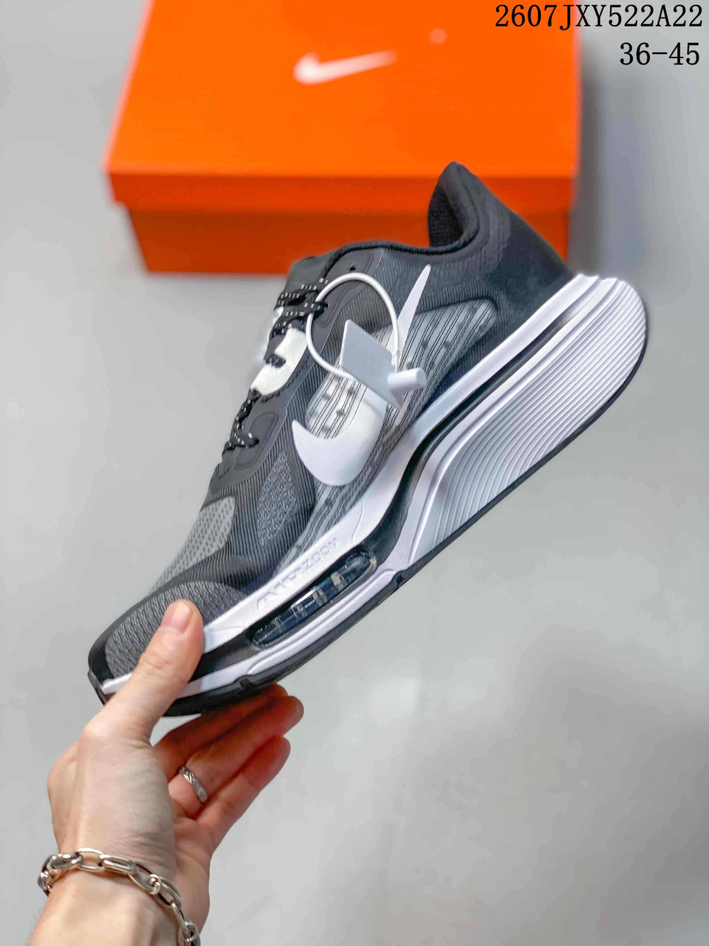 Side view of a Nike running shoe showing the white Swoosh, layered upper, and white midsole