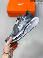 Side view of a Nike running shoe showing the white Swoosh, layered upper, and white midsole