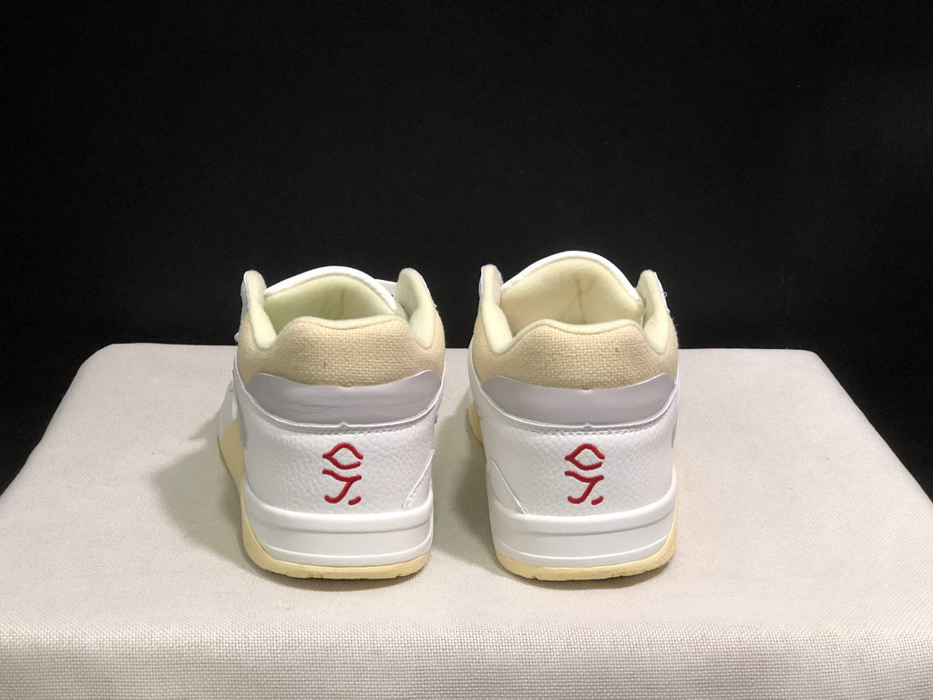 Rear view showing padded cream collars, white heel panels and red embroidered heel graphics.