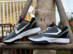 Pair of black, white, and red Nike Kobe 6 basketball shoes in side view