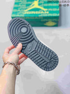 Close view of the dark textured rubber outsole with circular and linear traction patterns.