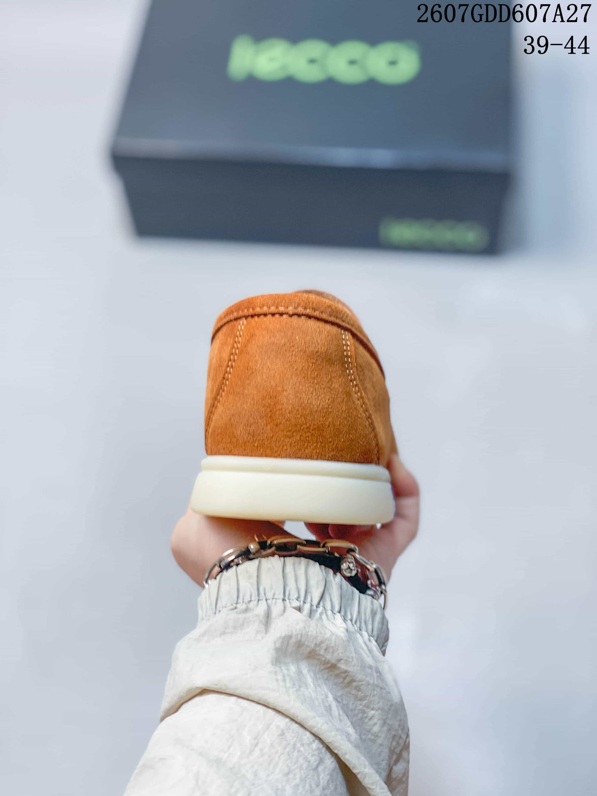 Rear view of a brown loafer showing the stitched heel and light-colored sole.