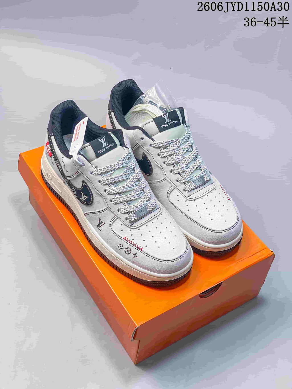 White and gray low-top sneakers with dark accents, patterned laces, and perforated toe panels