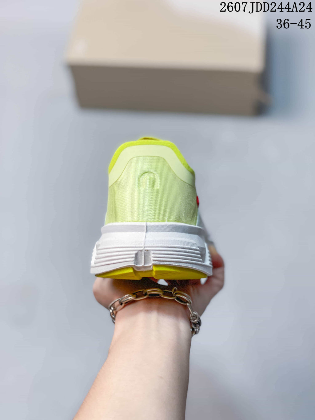Rear view of the sneaker showing the neon yellow-green heel collar, white midsole, and colored outsole section.