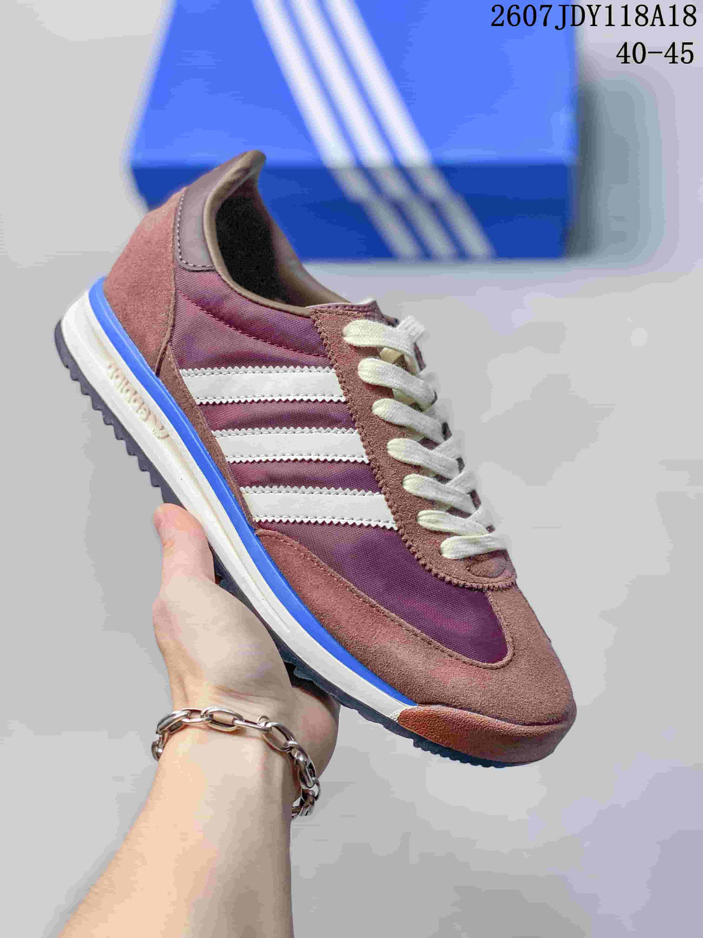 Muted pink and brown adidas SL 72 sneaker with white stripes and a blue outsole edge.