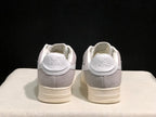 Rear view of the pair showing gray heel panels and BAPE Sta branding.